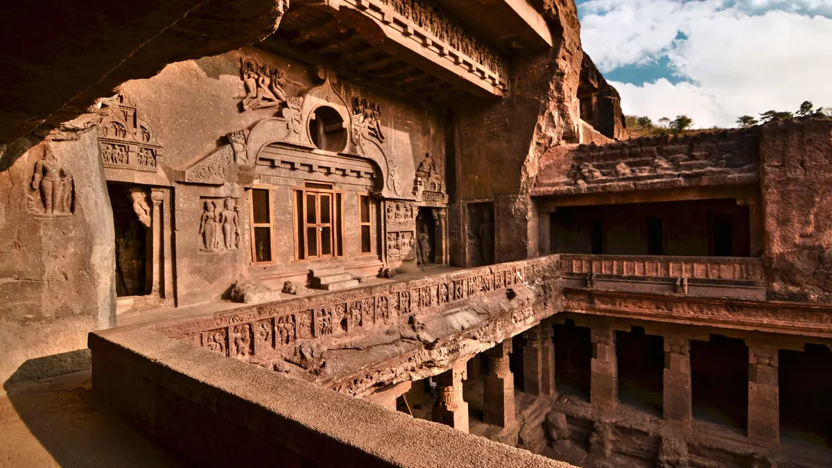 Explore the intricate rock-cut architecture of an ancient cave temple with exquisite carvings.
