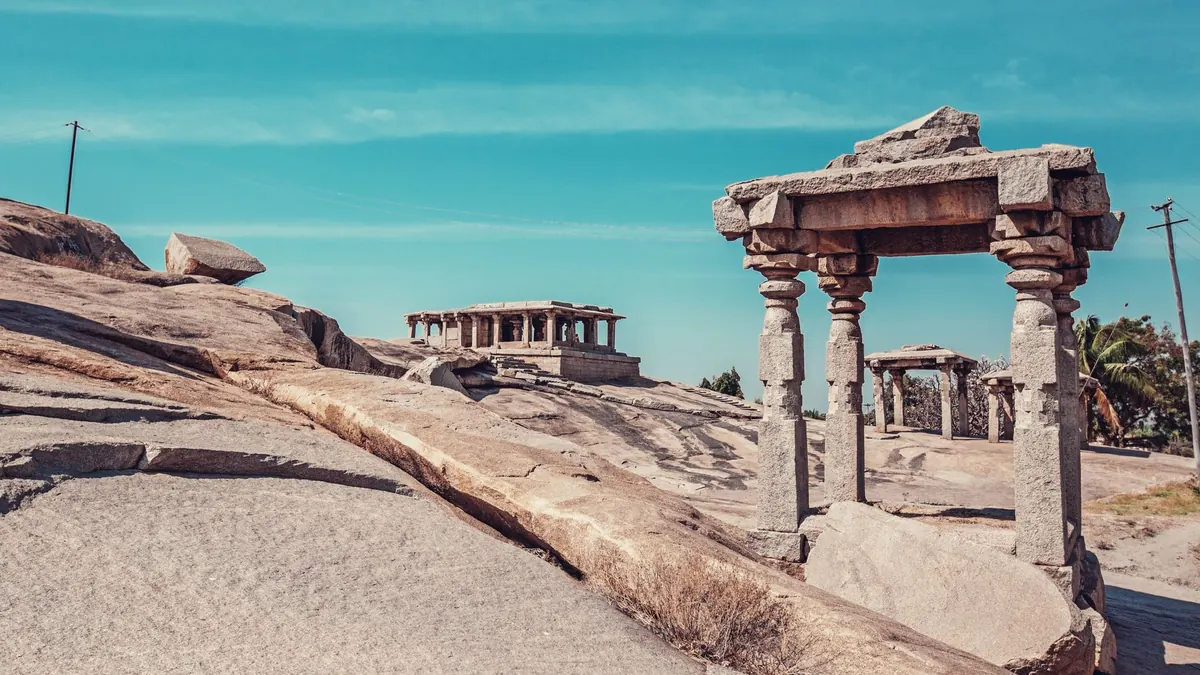 Amazing remnants of stone constructions with pillars in aged district of Anegundi in Hampi