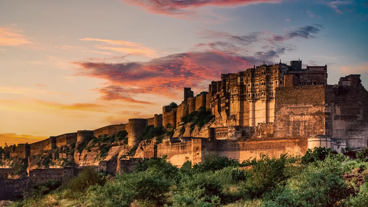 Stunning view of Mehrangarh Fort during a vibrant sunset in Jodhpur, India.
