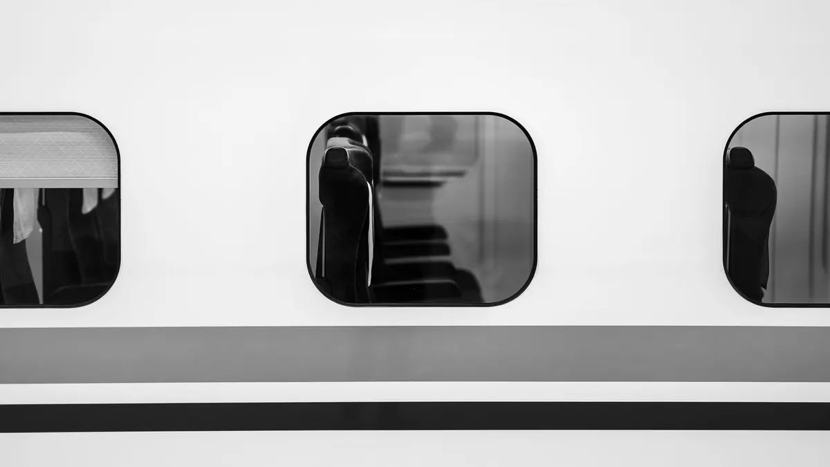 Black and white photo of Shinkansen windows highlights minimalist design.