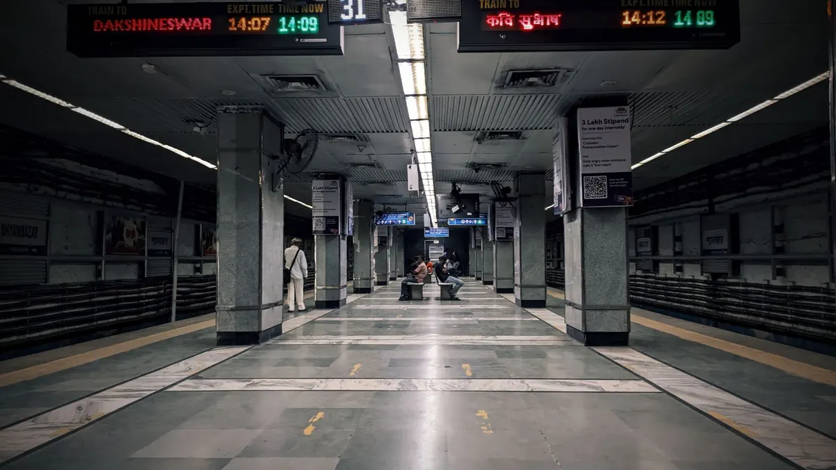 A view of Kolkata metro station platform with urban commuters.