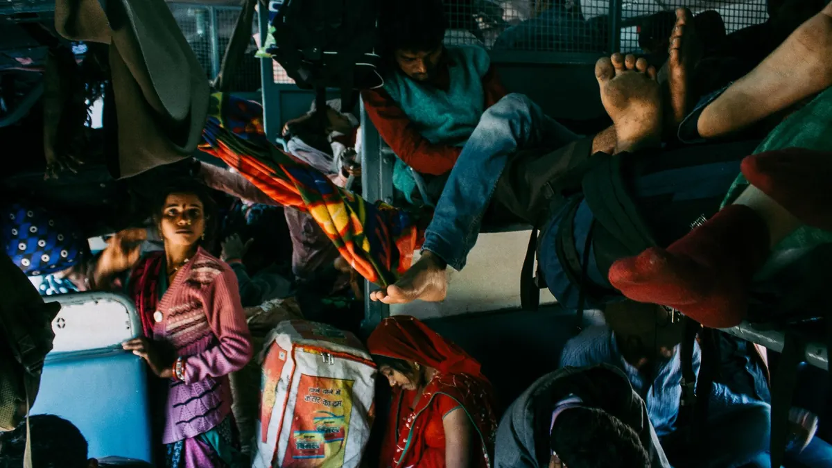 Bus with lying seats full of poor tourists in old fashioned clothes with suitcases and bags