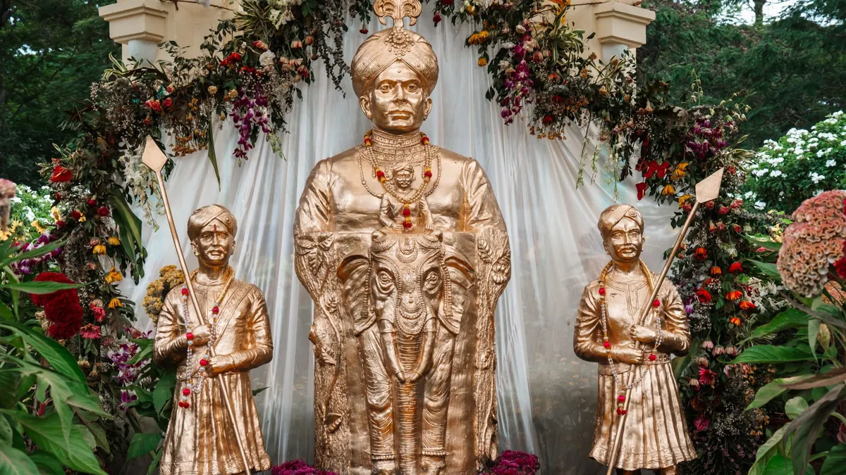 Golden statues displayed with floral decorations during Mysore Dasara in Karnataka, India.