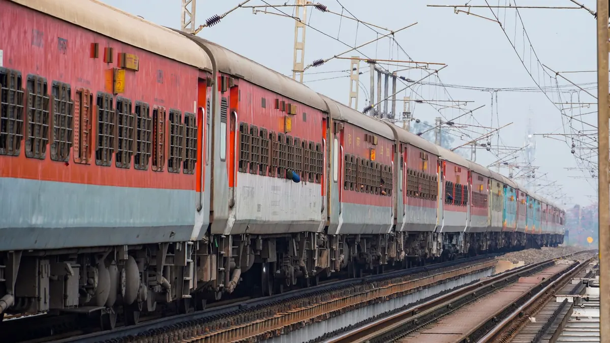 A passenger train traveling on elevated tracks, showcasing the Indian Railway system.