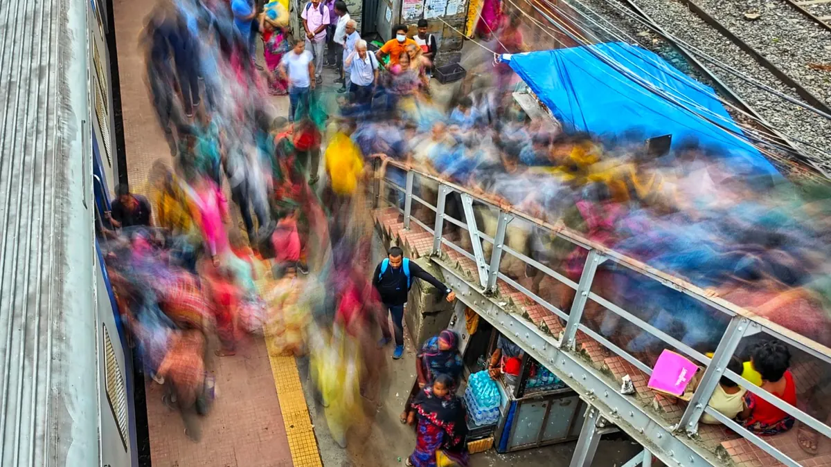 Vibrant motion blur capturing the bustling crowds at a Kolkata train station.