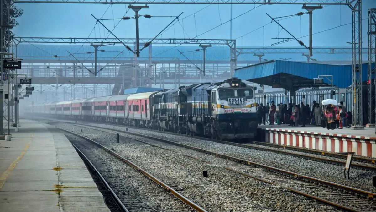 An express train arriving at a station platform with passengers waiting