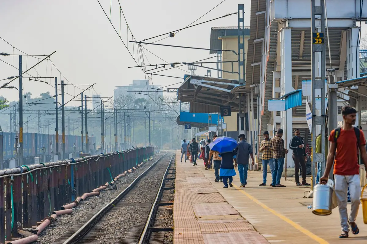 A busy railway platform with passengers beside the train